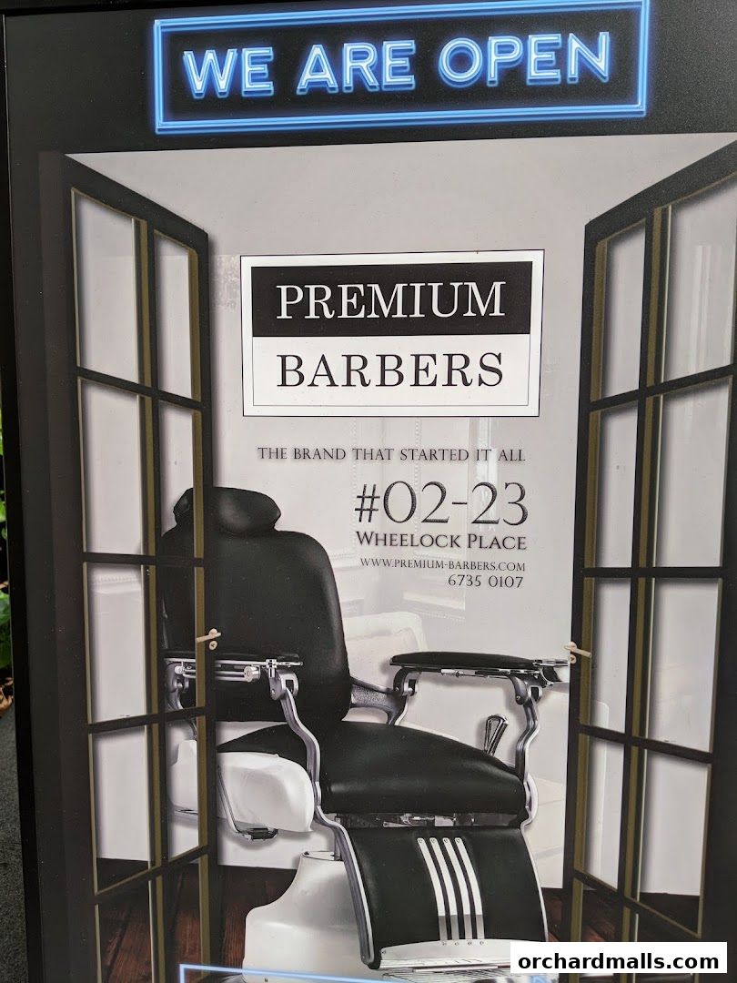 A vintage barber chair is displayed with the shop name 'Premium Barbers' and 'We Are Open' sign.
