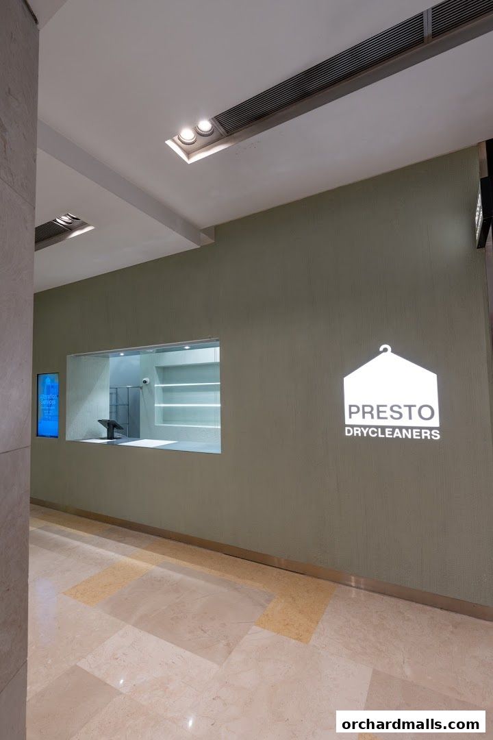 The entrance to Presto Drycleaners with its logo and a service window.