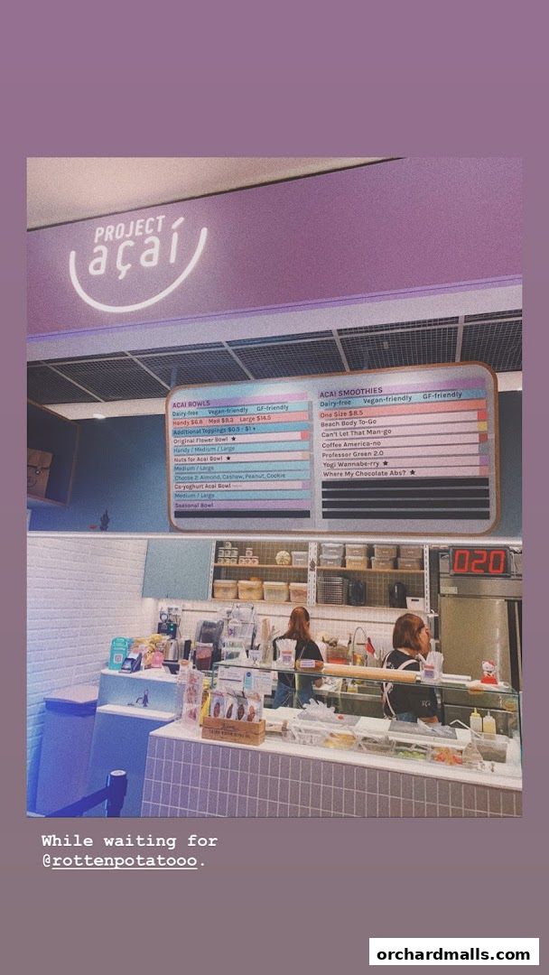 A menu board for Project Acai showing acai bowls and smoothies with prices.