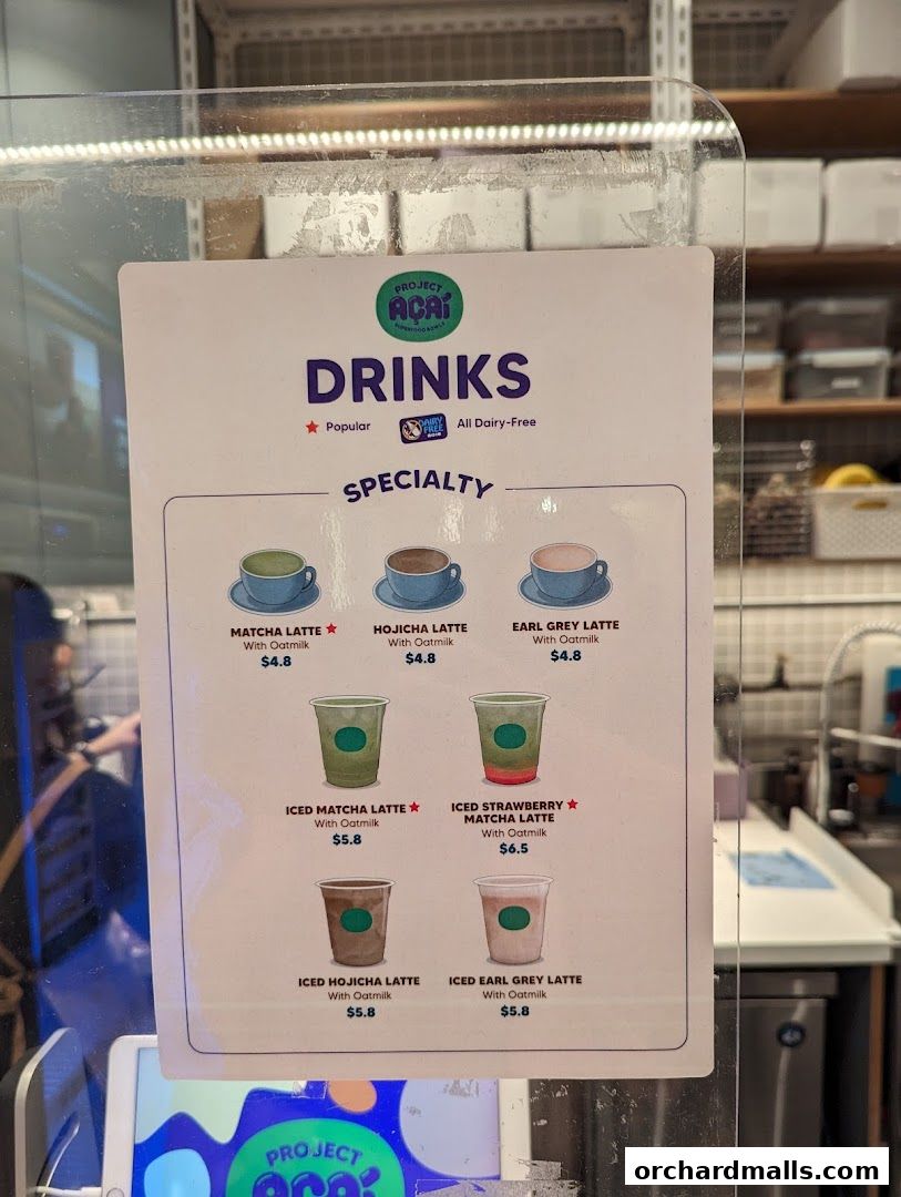 A menu board for Project Acai featuring specialty dairy-free drinks with oatmilk.