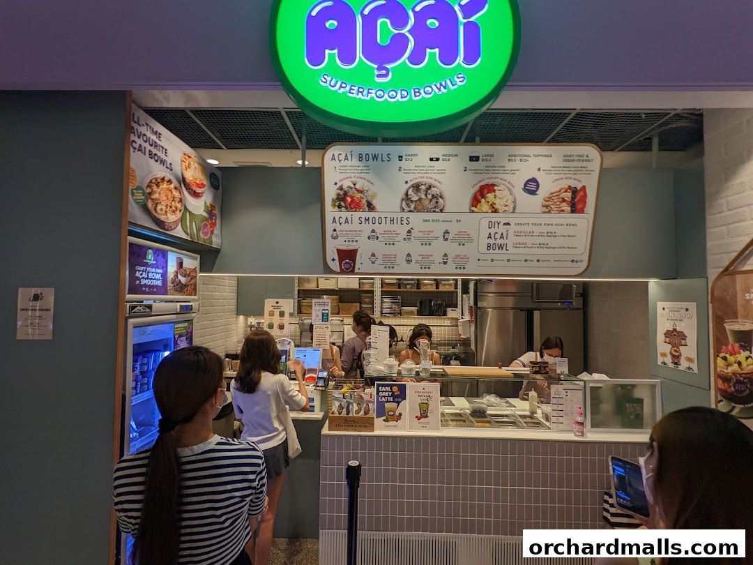 Project Acai Ngee Ann City shop front with a menu board and customers ordering.