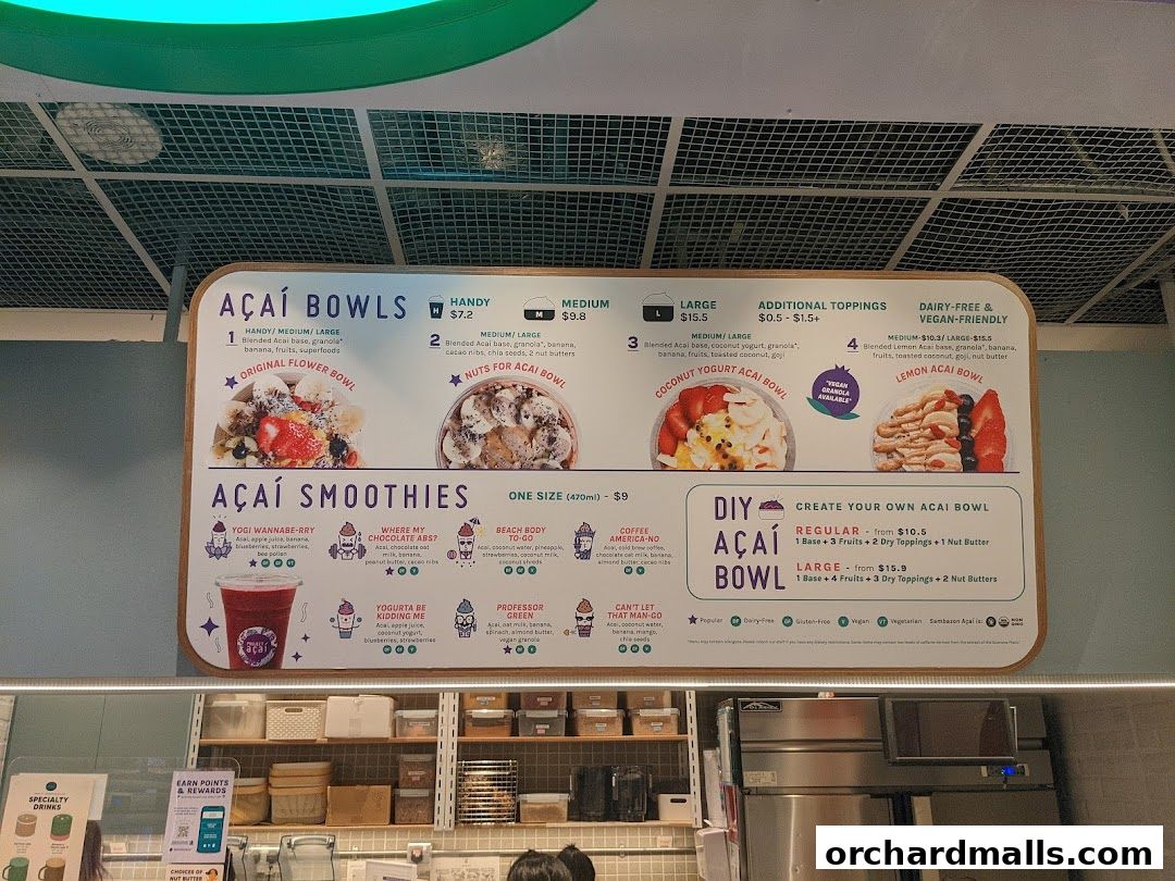 A menu board displays Acai bowls, smoothies, and DIY bowl options with prices.