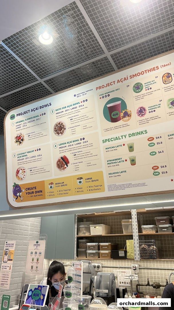 A menu board displaying Project Acai bowls, smoothies, and specialty drinks with prices.