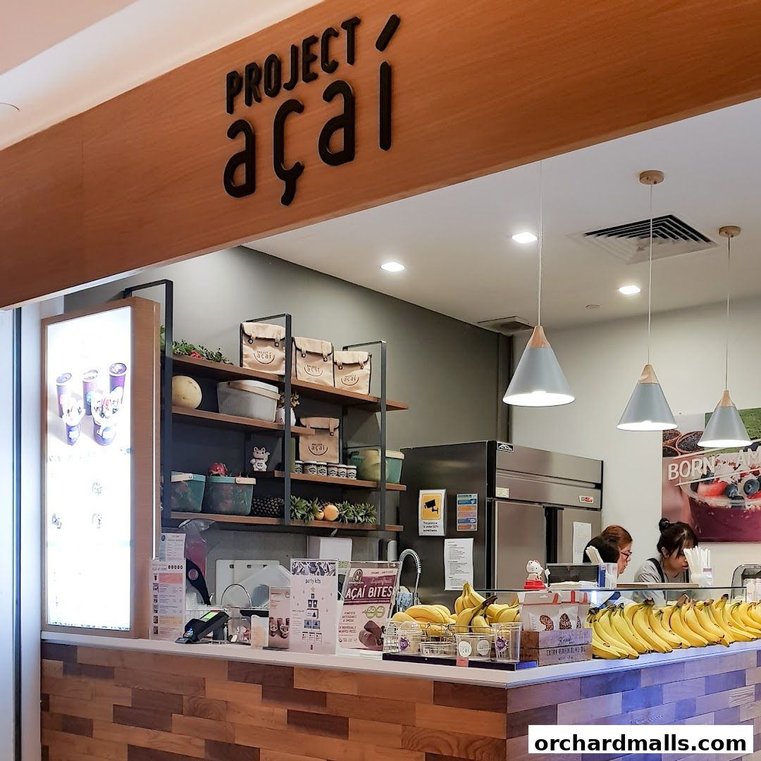 Project Acai Ngee Ann City shop counter with acai bowls, bananas, and staff.
