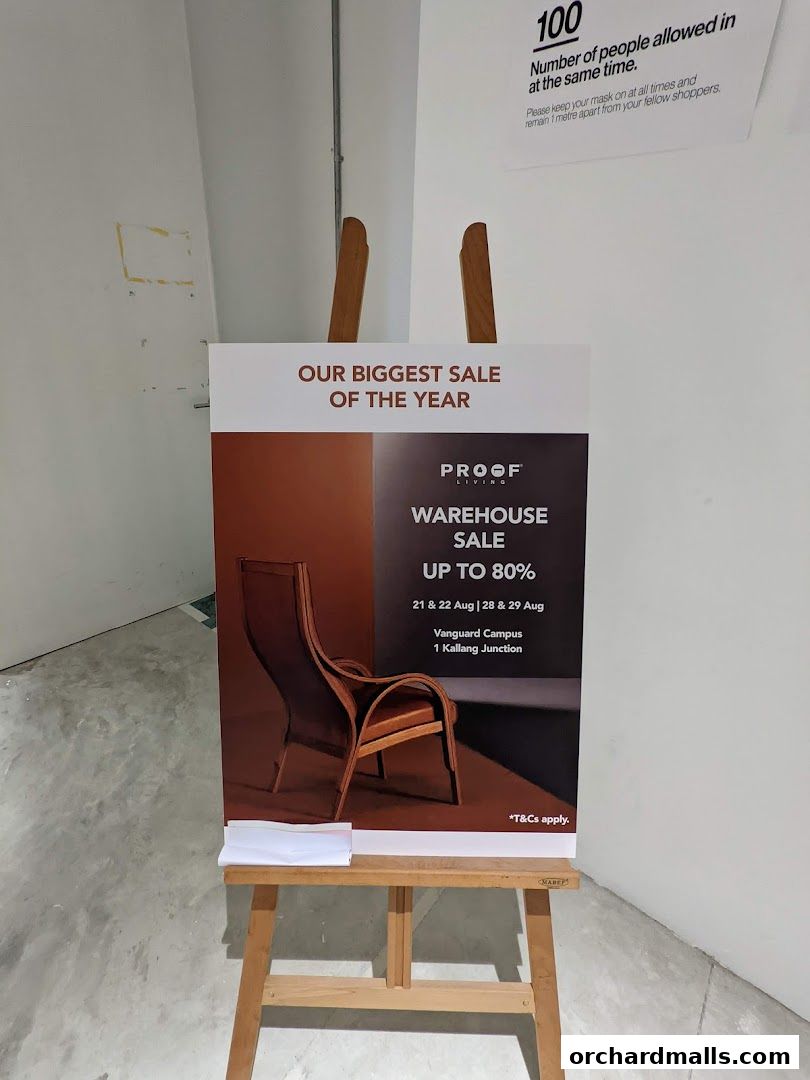 A sign advertising Proof Living's warehouse sale with discounts up to 80%.
