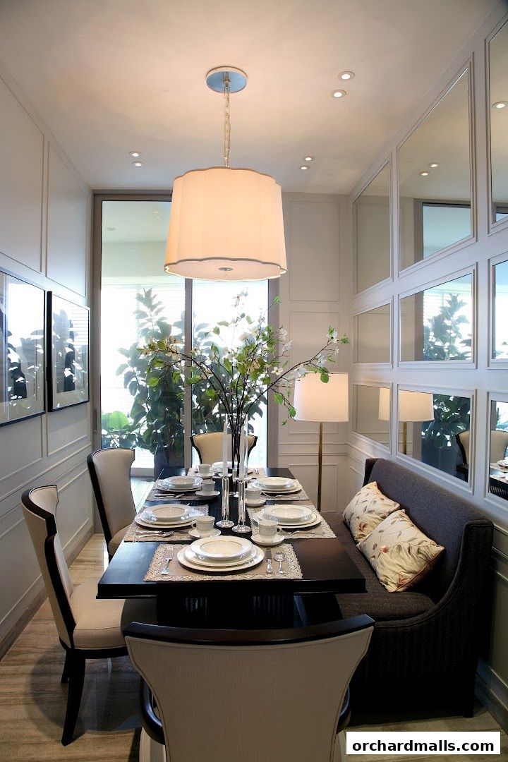 A beautifully set dining table with chairs and a bench, illuminated by a stylish pendant light.