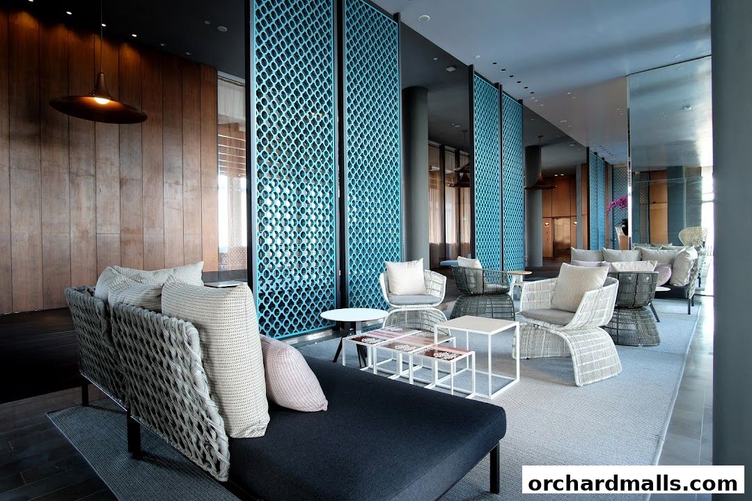 A modern lounge area with stylish seating, decorative screens, and warm wood accents.
