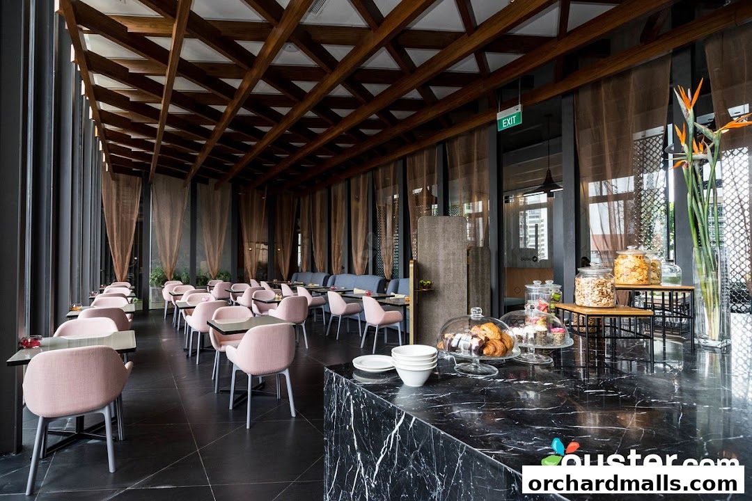 Interior of a modern restaurant with pink chairs and a marble counter.