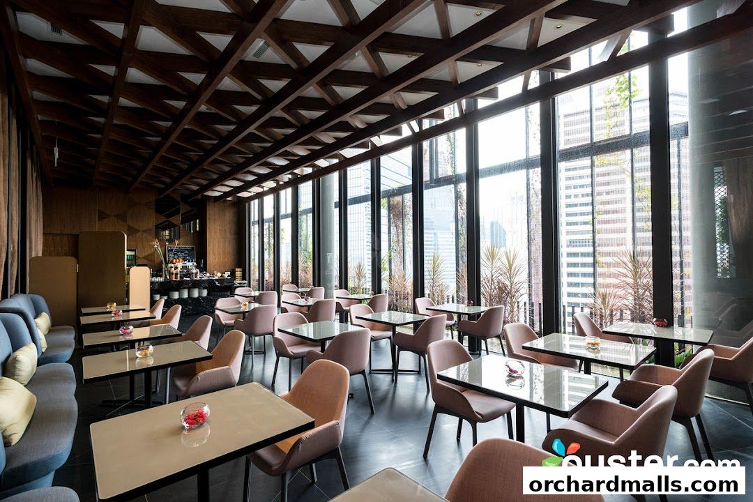 Interior of a modern restaurant with a view of city skyscrapers through large windows.