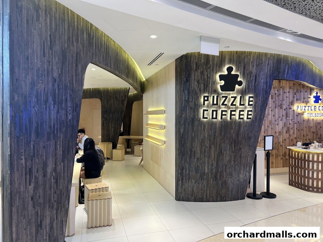 The interior of Puzzle Coffee shop with modern wooden design and seating areas.