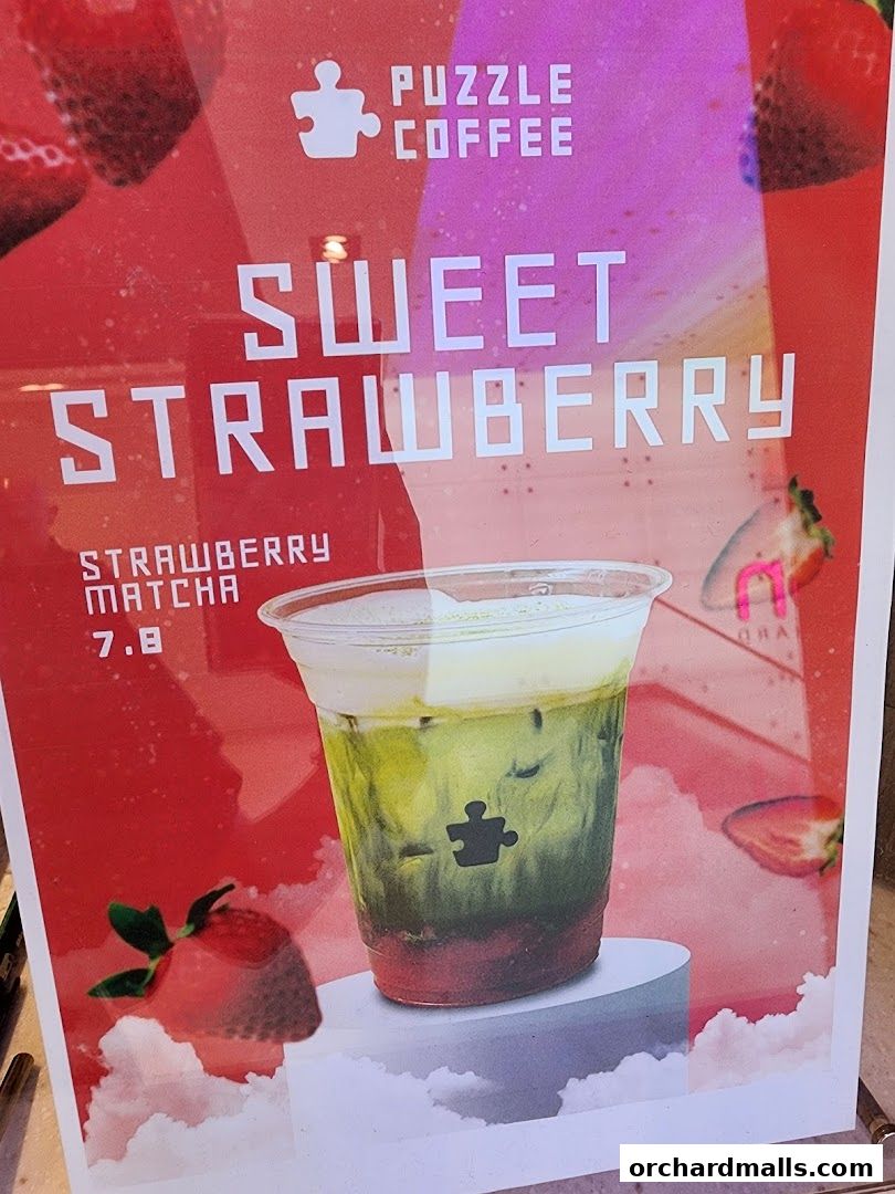 A promotional poster for Puzzle Coffee featuring a strawberry matcha drink.