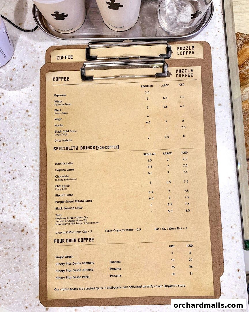 A menu board for Puzzle Coffee, featuring various coffee and specialty drink options with prices.