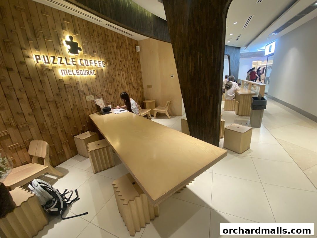 Interior of Puzzle Coffee shop with a long counter, wooden walls, and seating areas.