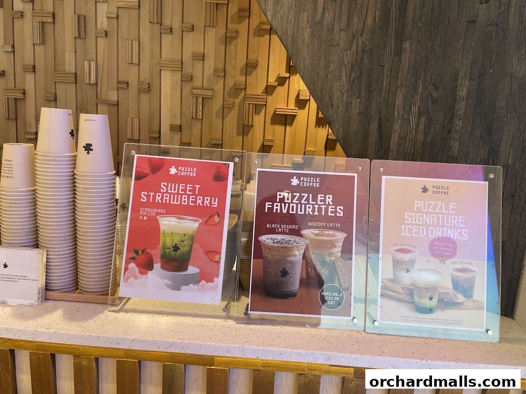 Display of drinks from Puzzle Coffee, featuring Sweet Strawberry, Puzzler Favourites, and Signature Iced Drinks.
