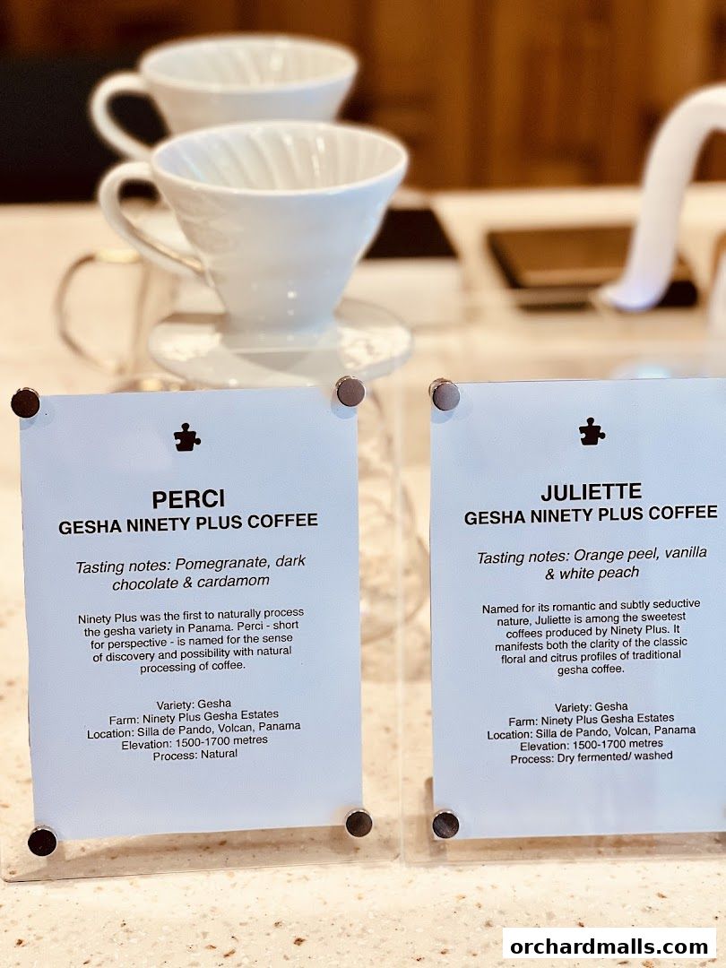 Two signs detailing different types of Gesha Ninety Plus Coffee.