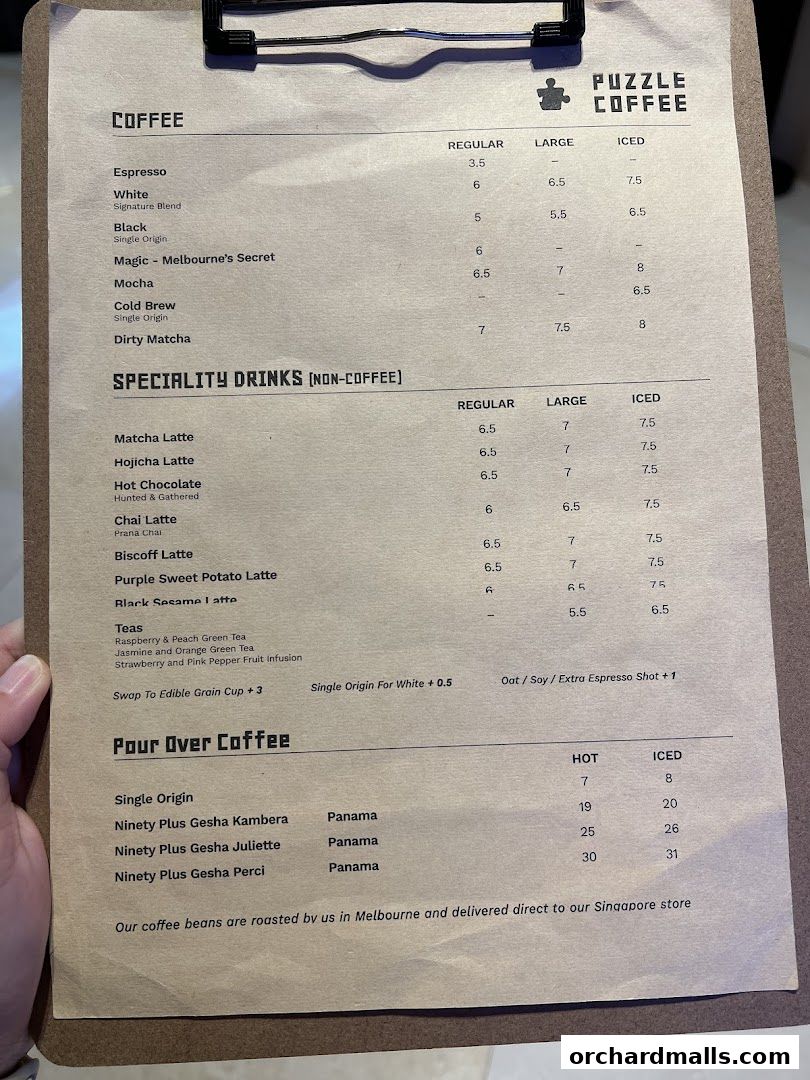 A close-up view of a coffee menu from Puzzle Coffee, detailing various drinks and prices.