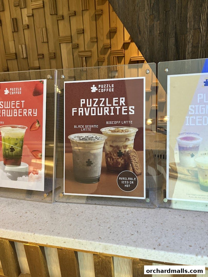 A display of three menu boards showcasing various coffee drinks from Puzzle Coffee.