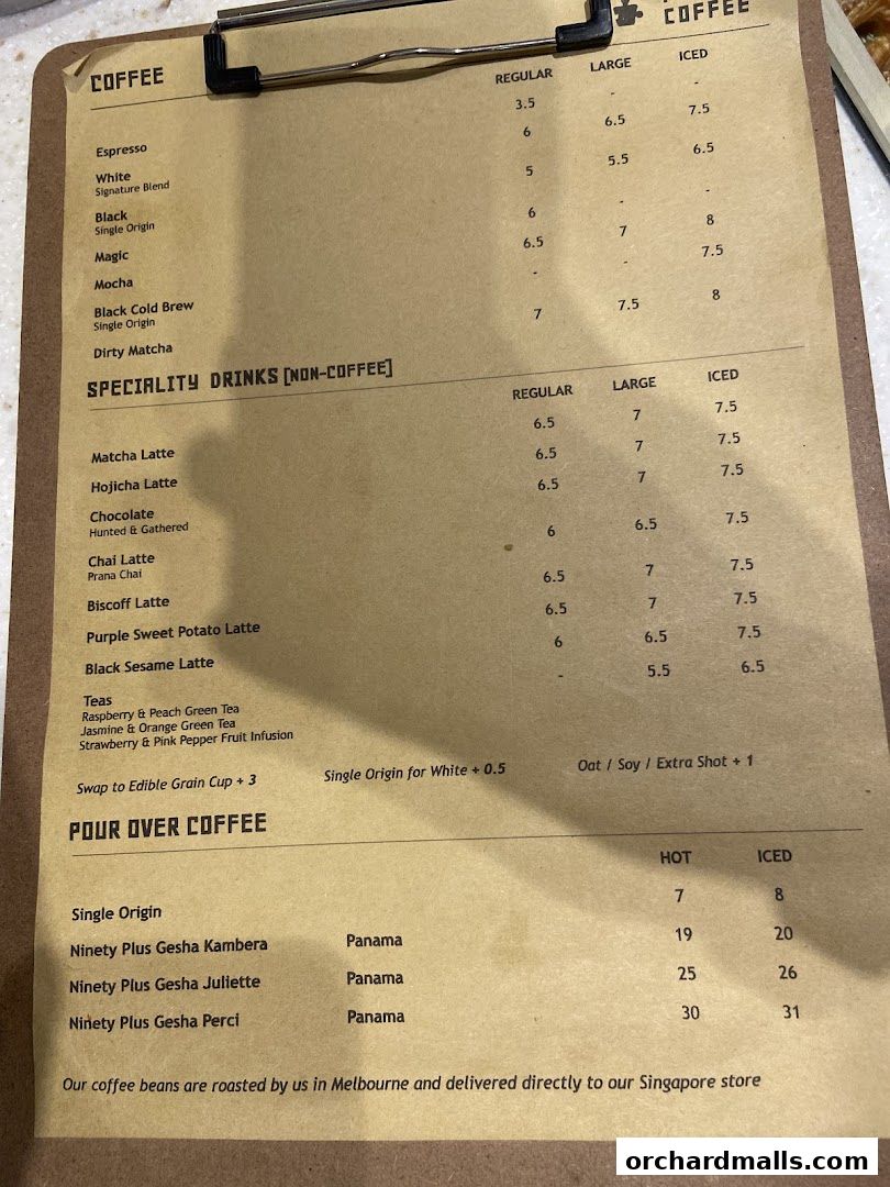 A close-up view of a coffee menu with various coffee and specialty drink options.
