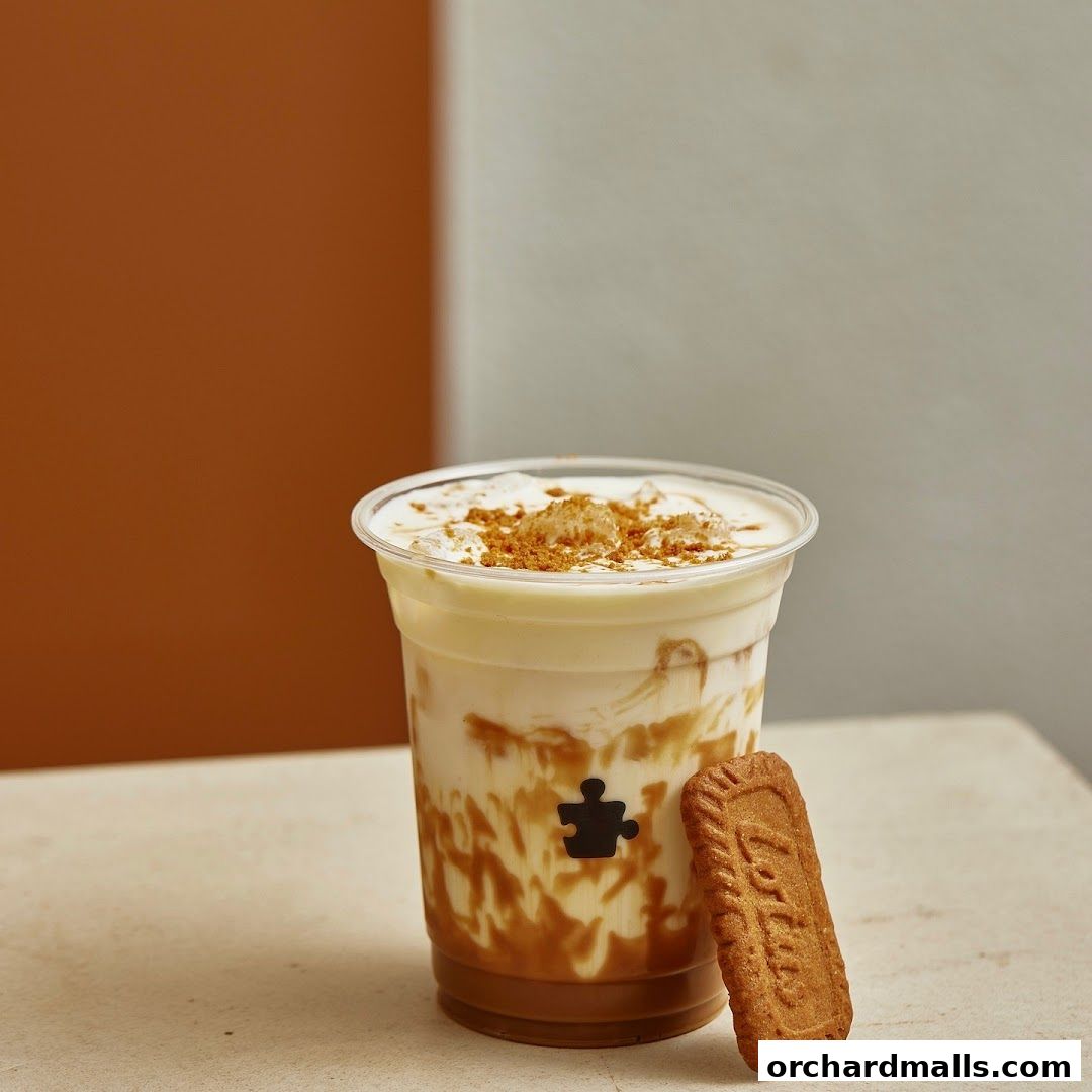 A refreshing iced coffee with caramel swirls and a biscuit, featuring the Puzzle Coffee logo.