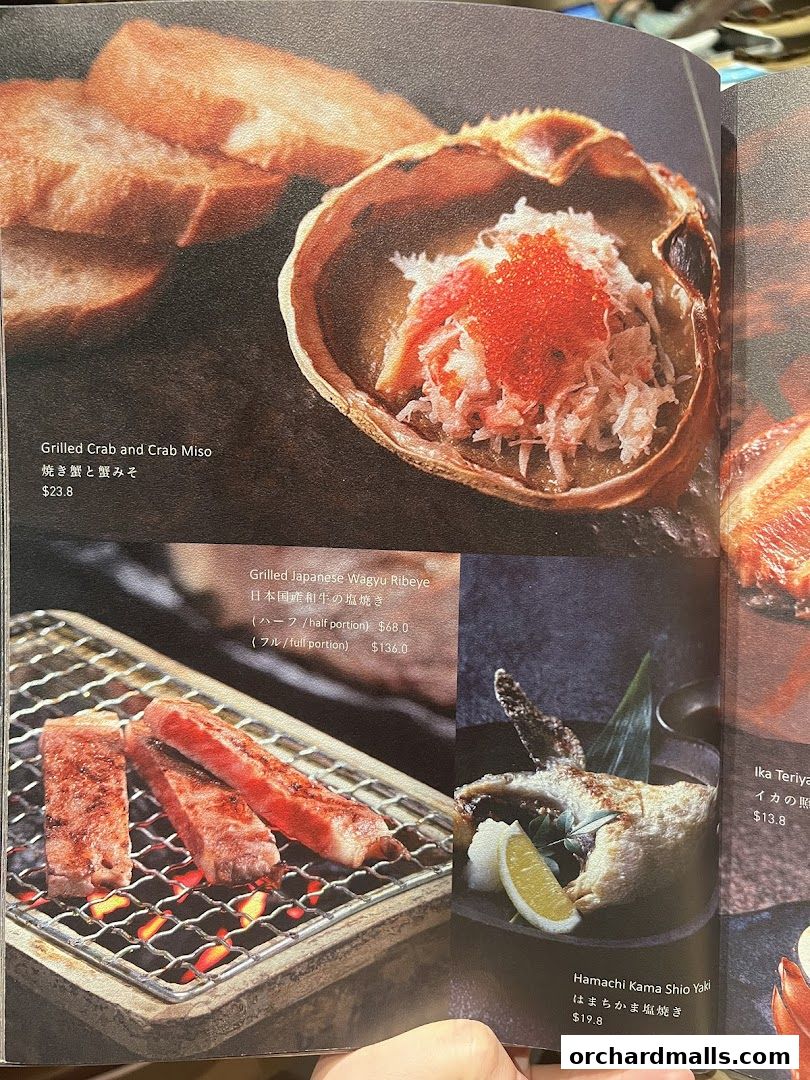 A menu page showcasing grilled Japanese dishes including crab, wagyu beef, and hamachi.