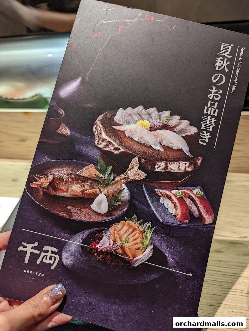 A hand holds a menu from Sen-Ryo featuring exquisite Japanese cuisine.