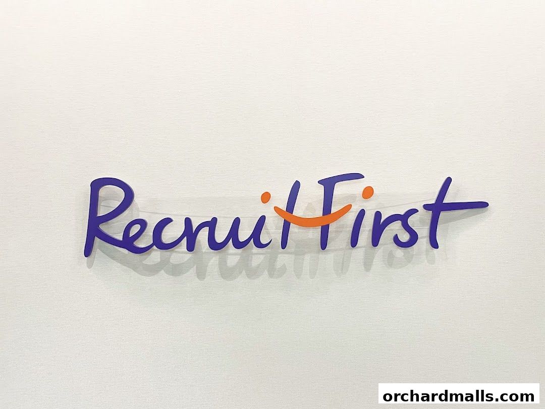 The RecruitFirst Singapore logo is displayed prominently on a textured white wall.