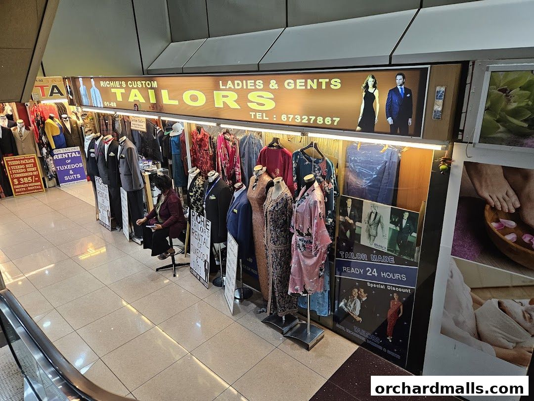 Richies Custom Tailors shop front displaying suits, dresses, and rental services for tuxedos.