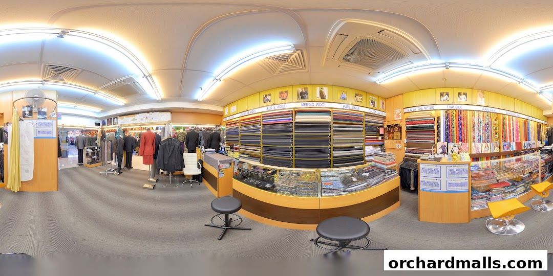 Interior view of a tailor shop showcasing a wide selection of fabrics and finished garments.