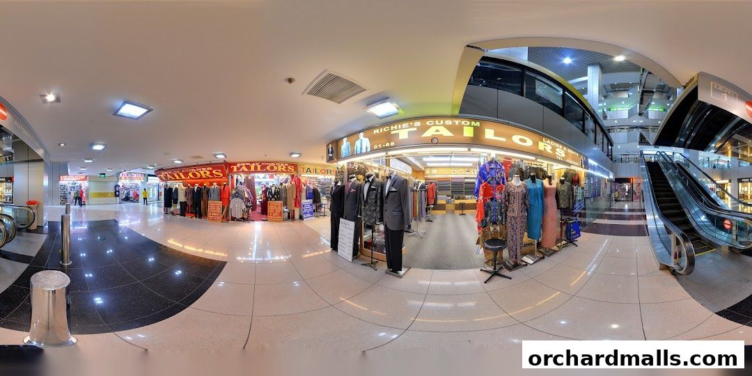 A panoramic view of Richie's Custom Tailors shop front with mannequins displaying suits and dresses.