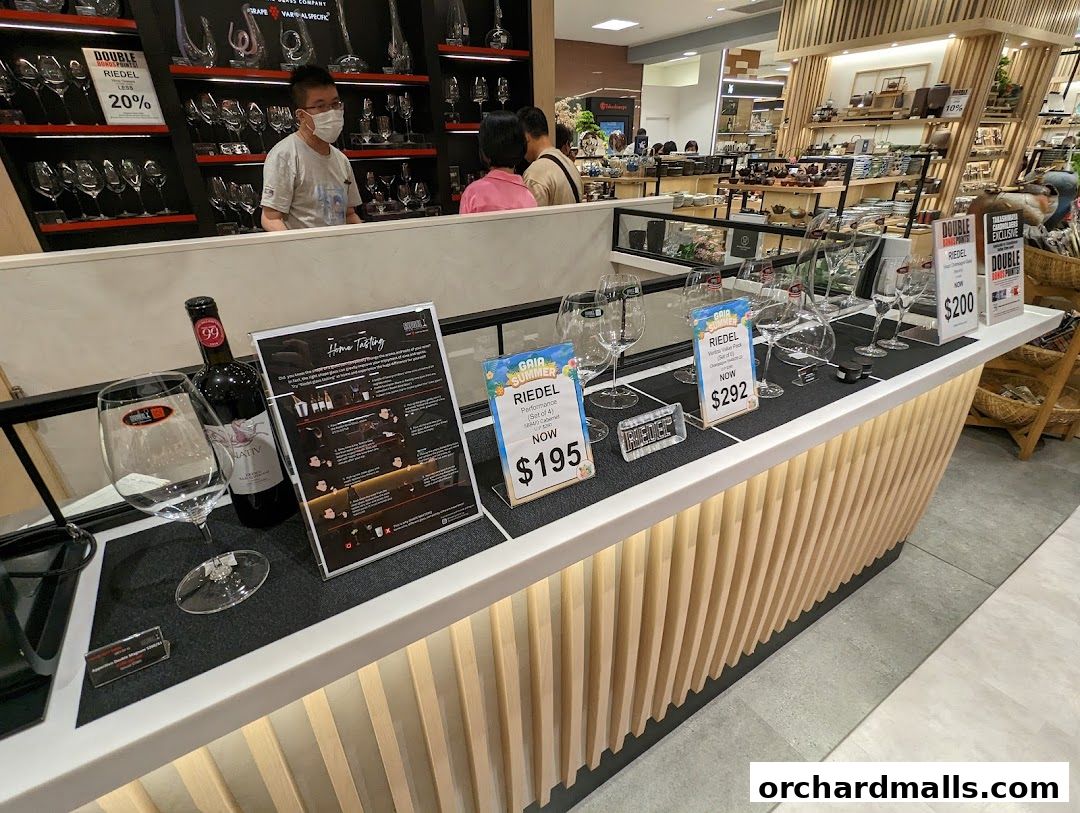 Riedel glassware and wine tasting display with promotional signage.