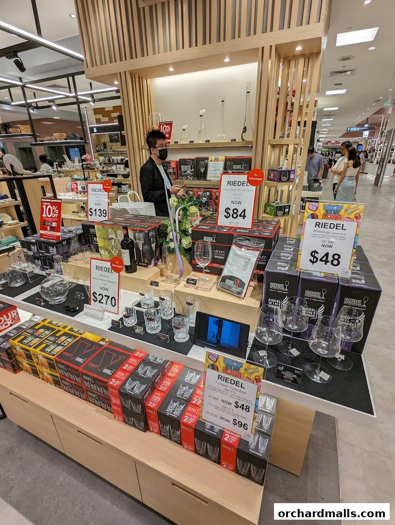 A display of Riedel glassware and wine accessories with promotional pricing.