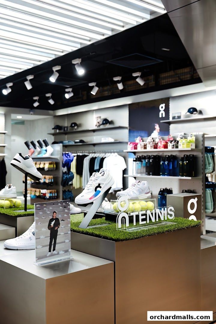 Interior of a modern sports shoe store displaying tennis shoes and apparel.