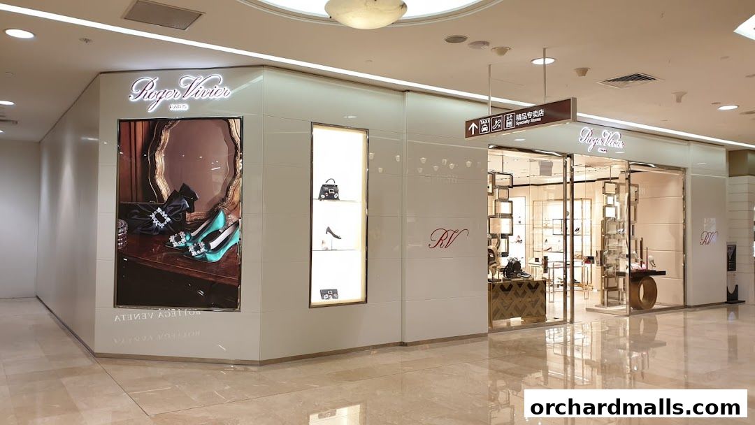 The elegant Roger Vivier boutique entrance showcases luxury footwear and handbags with illuminated displays.