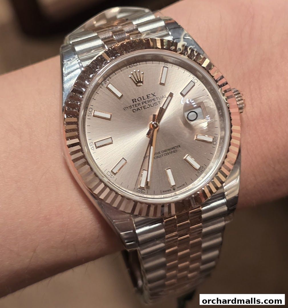 A close-up shot of a Rolex Oyster Perpetual Datejust watch on a wrist.