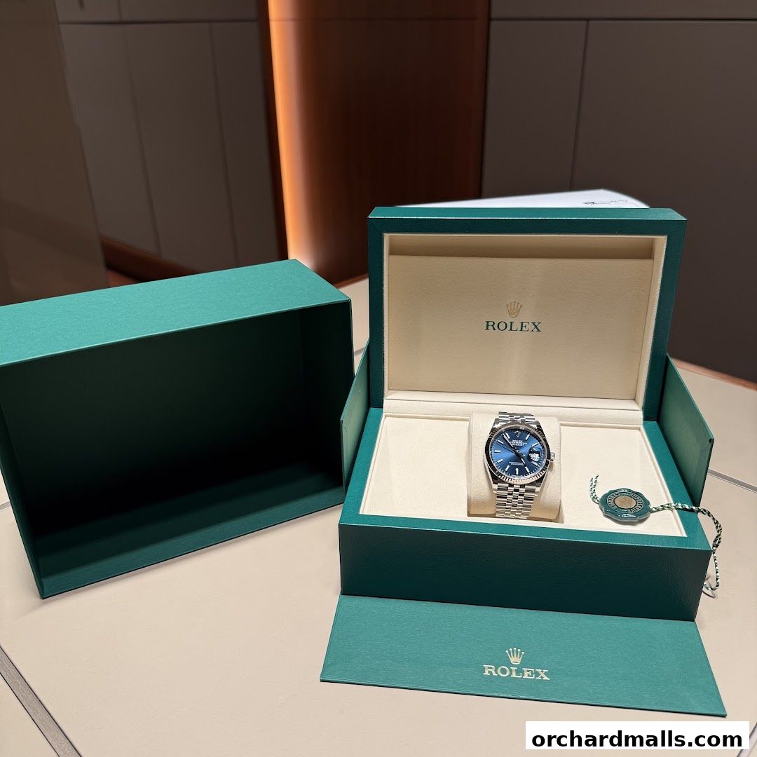 A Rolex watch displayed in its signature green box with accompanying packaging.