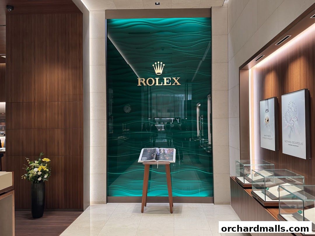 Interior view of a luxurious Rolex boutique with a prominent green wave-patterned wall and display cases.