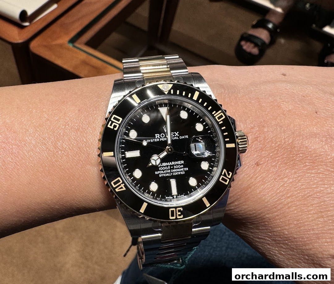 A close-up shot of a Rolex Submariner watch on a person's wrist.