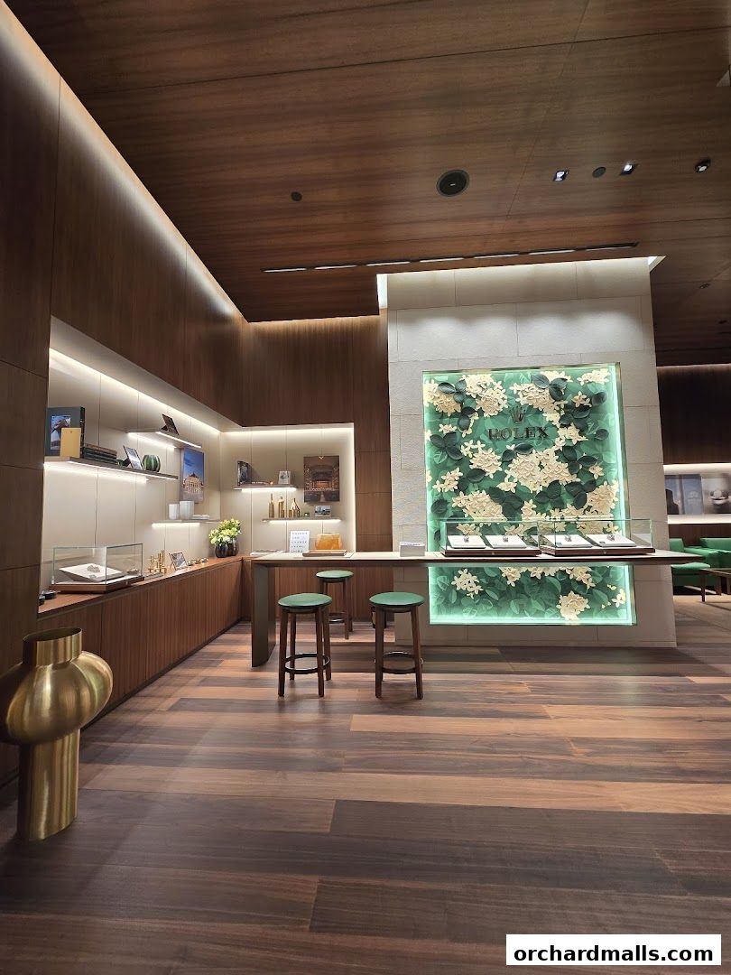 Interior of a luxurious Rolex boutique with display cases and seating.