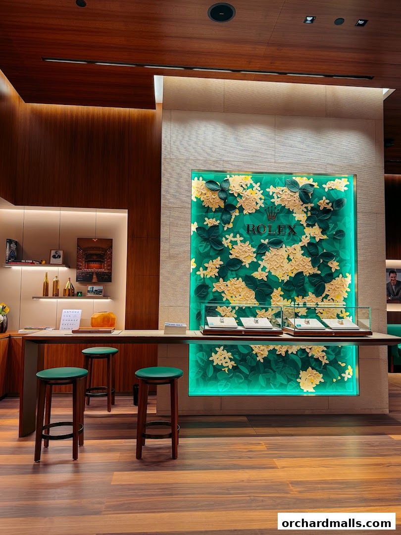 Interior of a luxury Rolex boutique with display cases and seating.