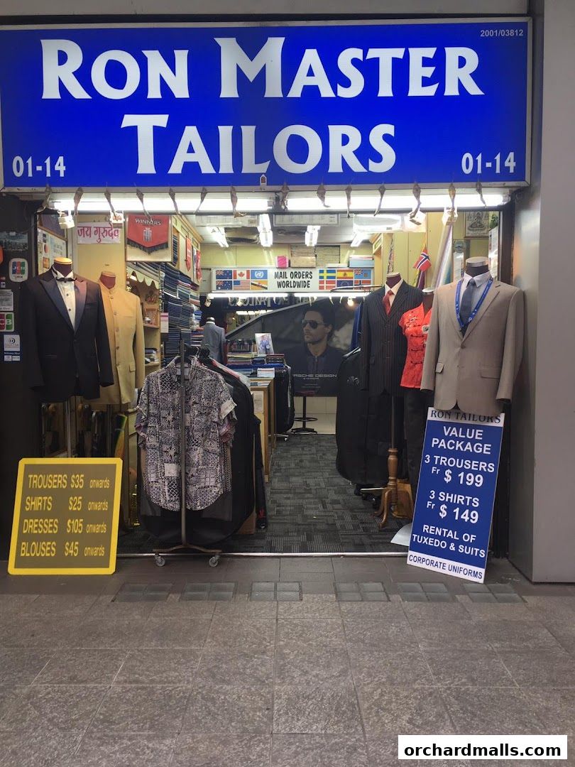 Exterior of Ron Master Tailors shop with mannequins displaying suits and a price list.