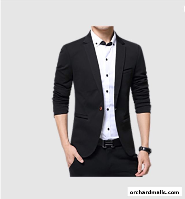 A man wearing a black suit jacket and white shirt, showcasing tailored fashion.