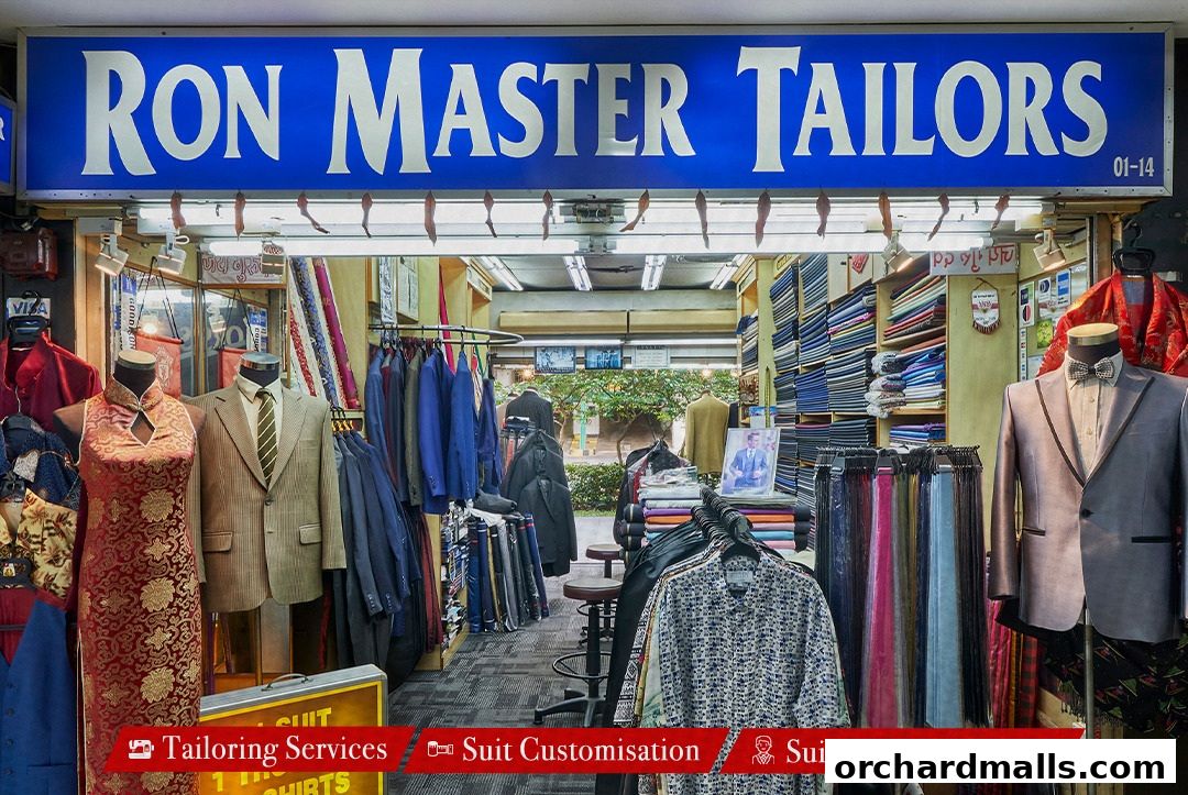 Exterior view of Ron Master Tailors shop showcasing suits, fabrics, and tailoring services.