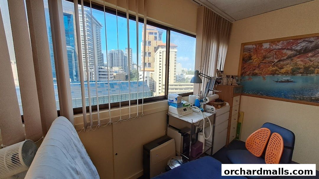 Interior view of a treatment room with a large window overlooking a city skyline.