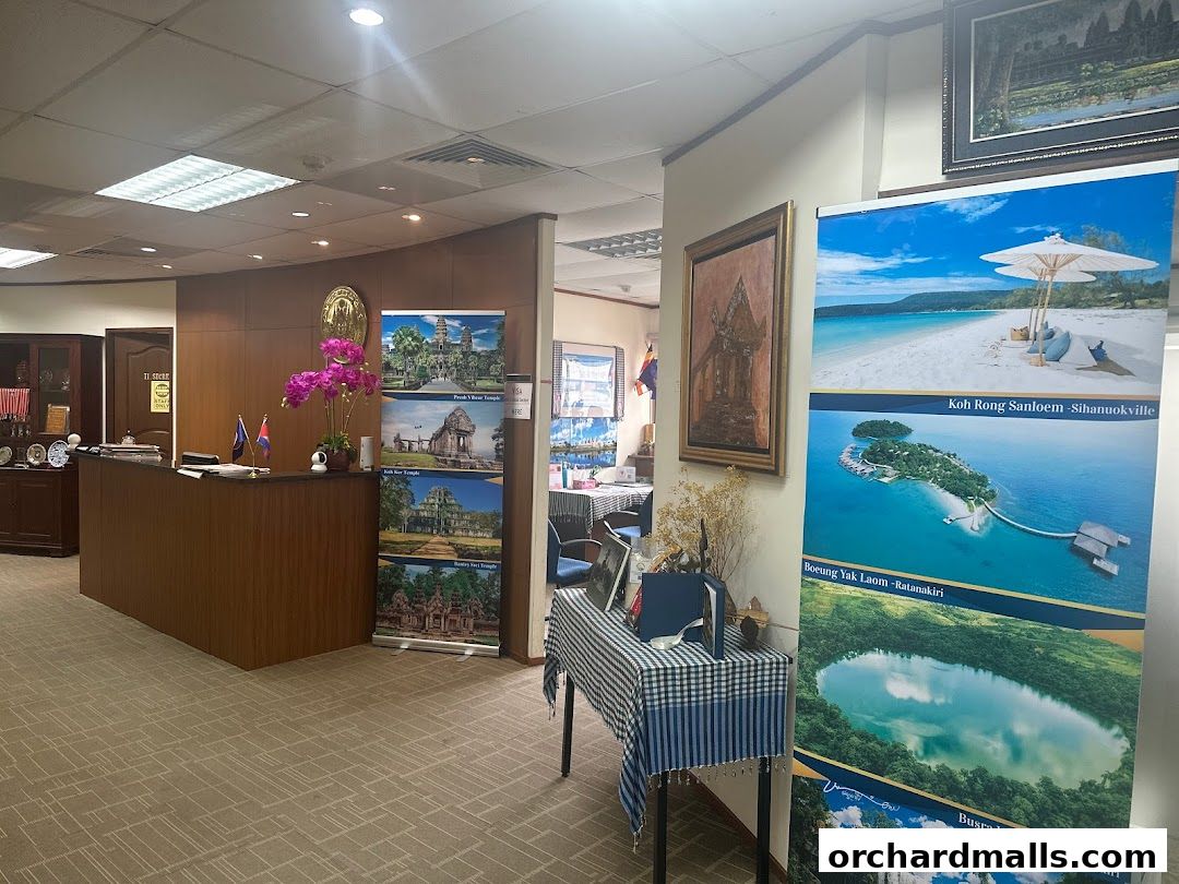 Interior of the Royal Embassy of Cambodia with promotional posters and a reception desk.