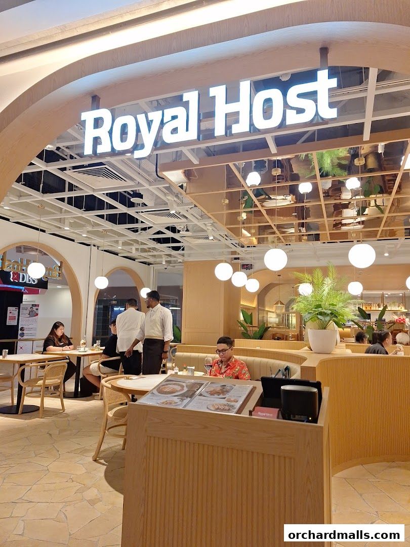 Interior view of Royal Host restaurant with diners and staff.