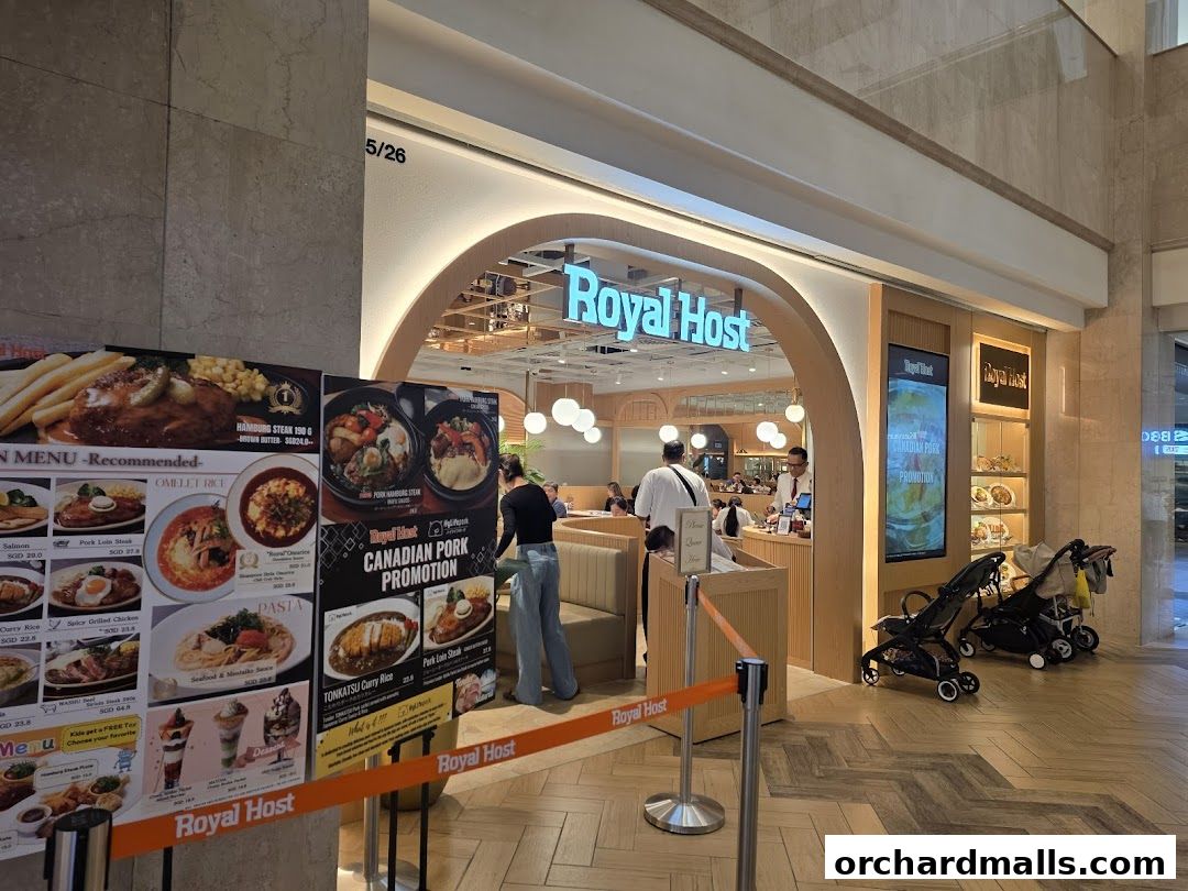 The entrance of Royal Host restaurant with a menu display and seating area visible.