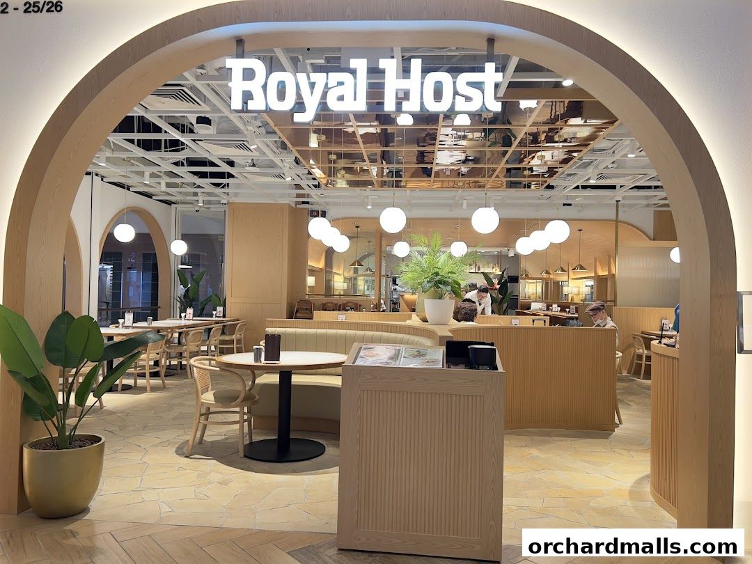Entrance to Royal Host restaurant with modern wooden interior and seating.