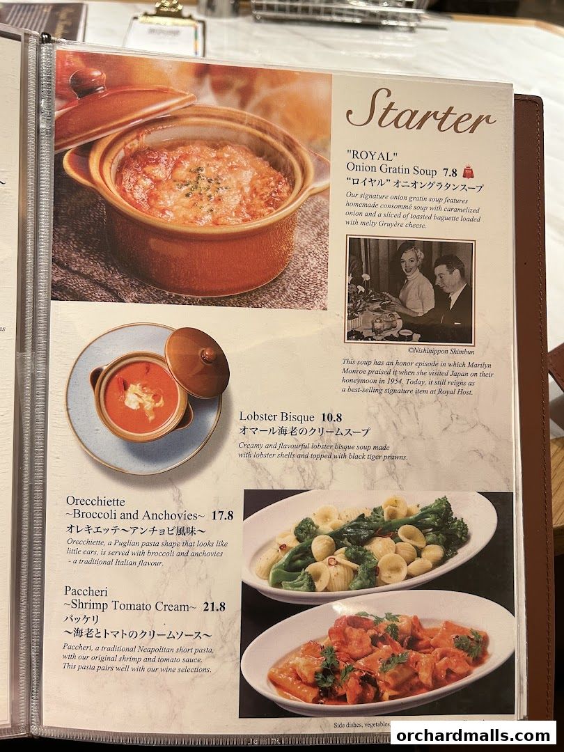 A menu page showcasing starters like onion gratin soup, lobster bisque, and pasta dishes.