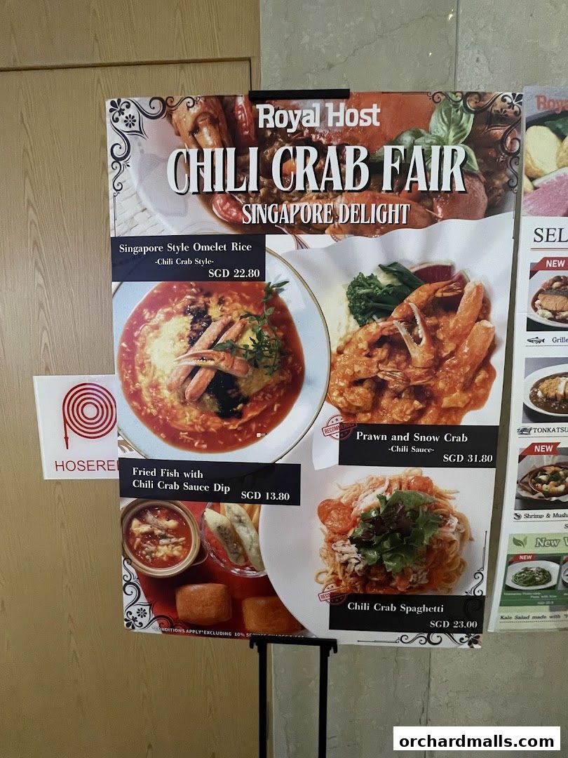 A menu board advertising Royal Host's Chili Crab Fair with various seafood dishes.