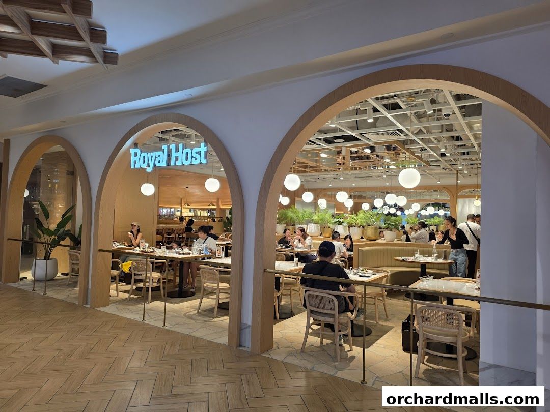 Interior view of Royal Host restaurant with diners seated at tables and a bright, modern ambiance.
